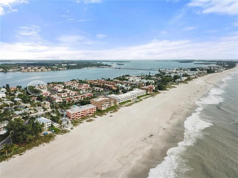 Aerial view showing highlighted condo on the bay, just across Gulf Drive from Bradenton Beach and the powdery sands on The Gulf.