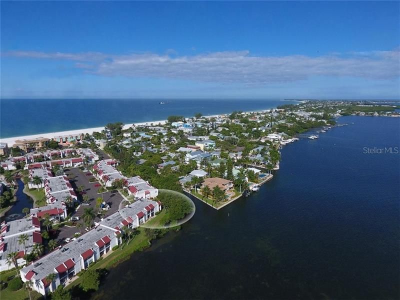 View of the circled condo, direct bay front and a beach access to The Gulf of Mexico.