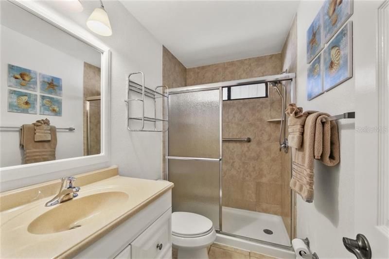 Master en suite bathroom with updated walk in shower, tile floors, newer vanity and natural light as this is an end unit with bathroom window.