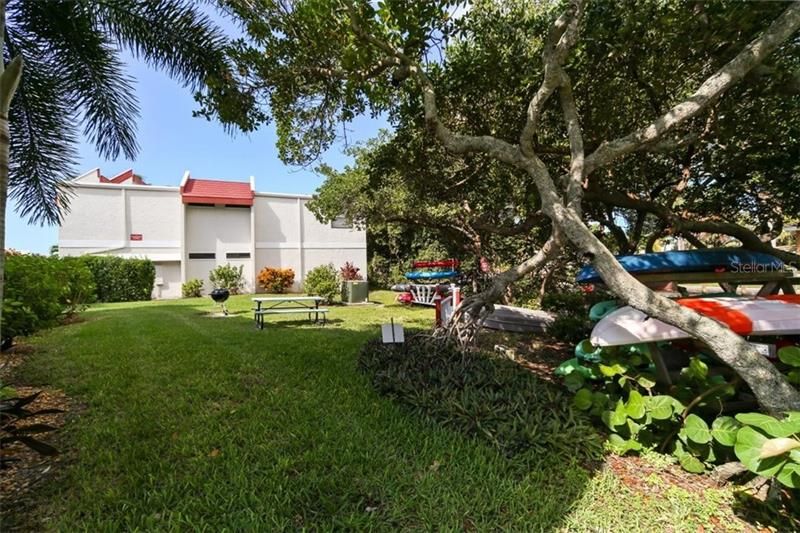 A grilling area is just along the side of this condo with a picnic table for al fresco dining and a kayak storage and launch to the bay.