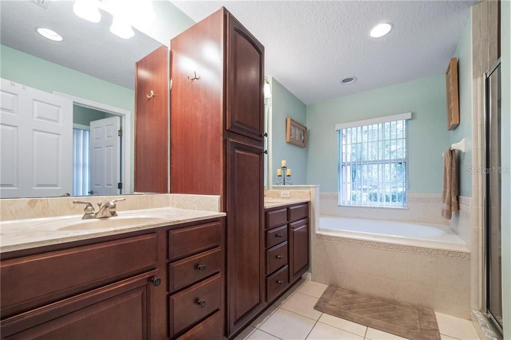 beautiful master bathroom with walk in shower, garden tub and tons of cabinet space.