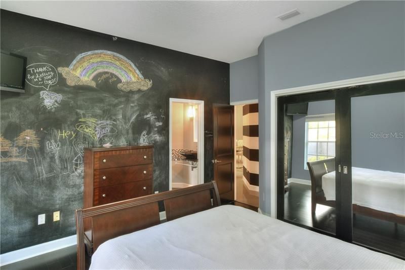 Bedroom 1 with Chalk Wall designed for the budding artist.  Shares Jack n Jill Bathroom.