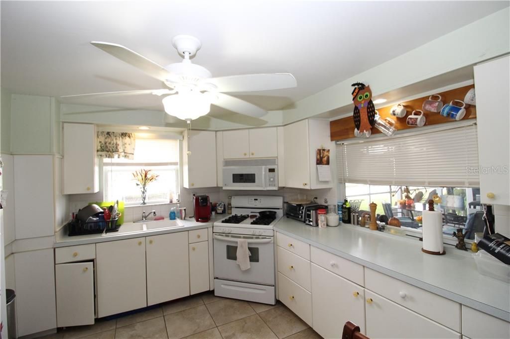 Kitchen with plenty of counter space for prepping.  Pass through window out into the lanai.  Gas range.