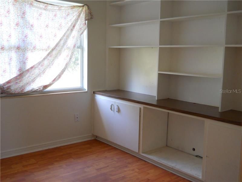 Bedroom with built in shelves/cabinets