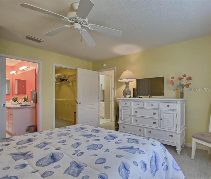 LIGHT AND BRIGHT MASTER BEDROOM WITH CARPET FLOORING AND CEILING FAN. AND WALK-IN CLOSET.