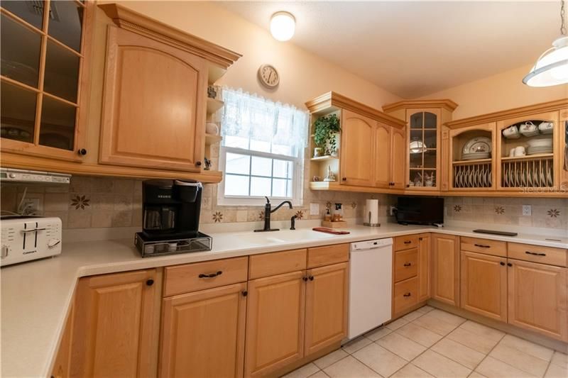 Note the tile backsplash and the natural light from the Kitchen window.
