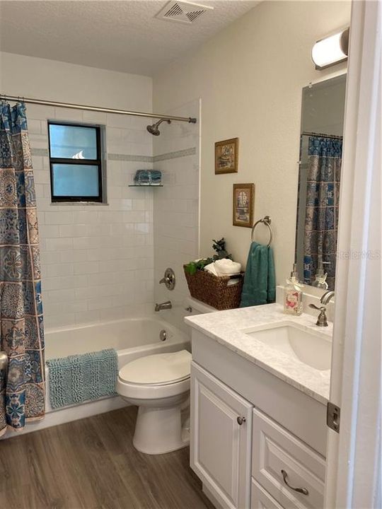 Main bath, right next to the 2nd bedroom, and across from the garage door. Very handy! All new