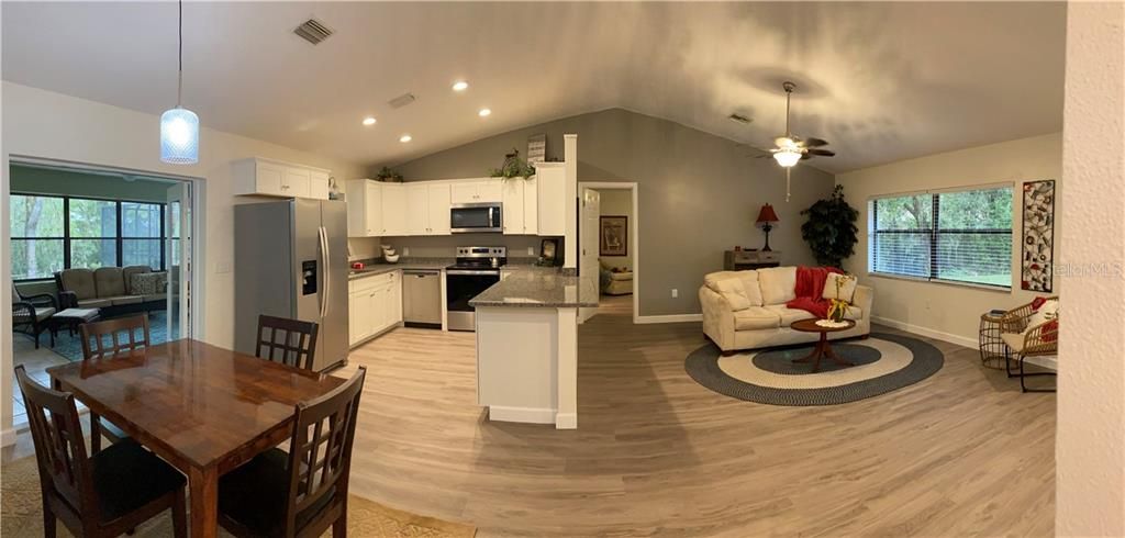 Panoramic picture of the living space including a look at the Florida room to the left.