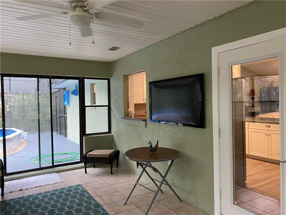 Sliding doors to the caged lanai where you will find the pool and great views out back.