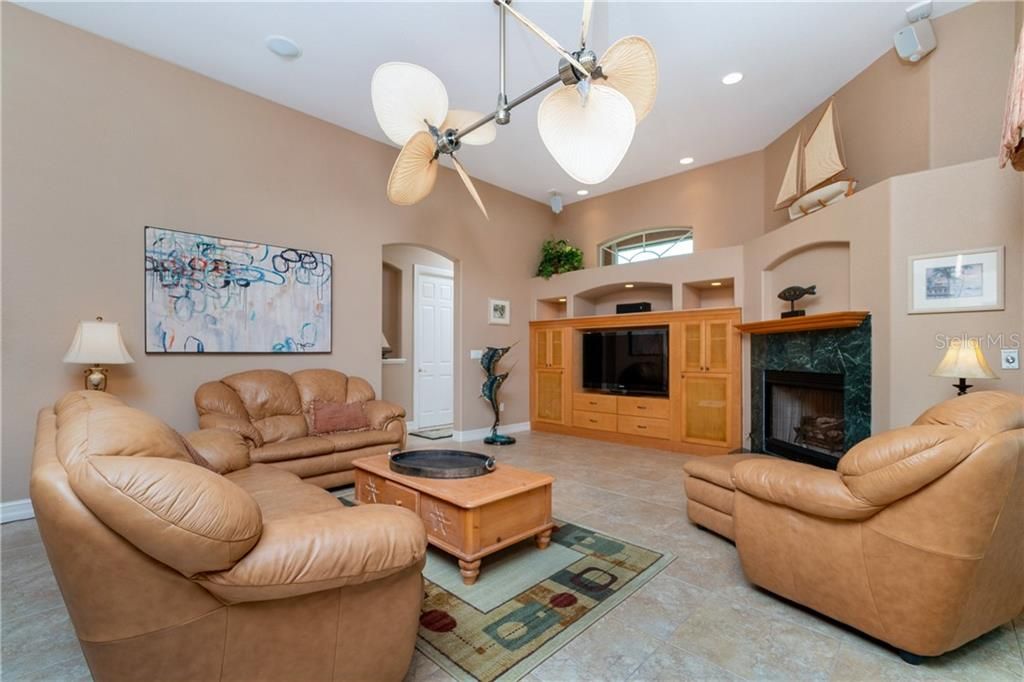 Built-in entertainment center and tropical fans are some of the custom features of this living space