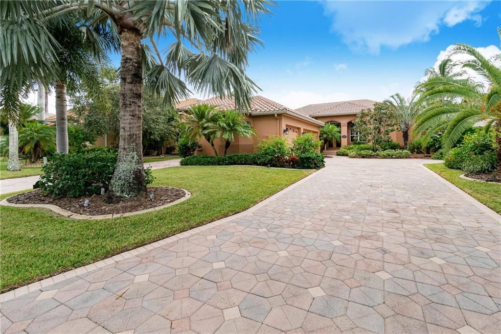 Two long paver driveways lead to the main 3 car garage and RV garage.