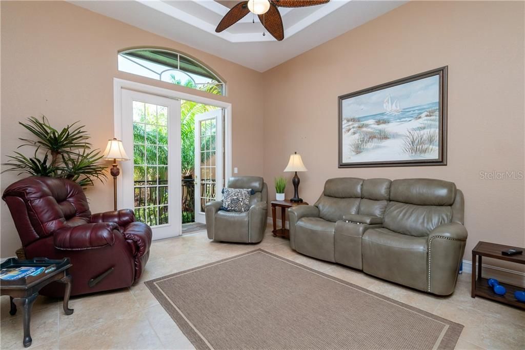 Formal dining room is currently being used as a media room and enjoys double doors leading to a quaint balcony overlooking the front courtyard.