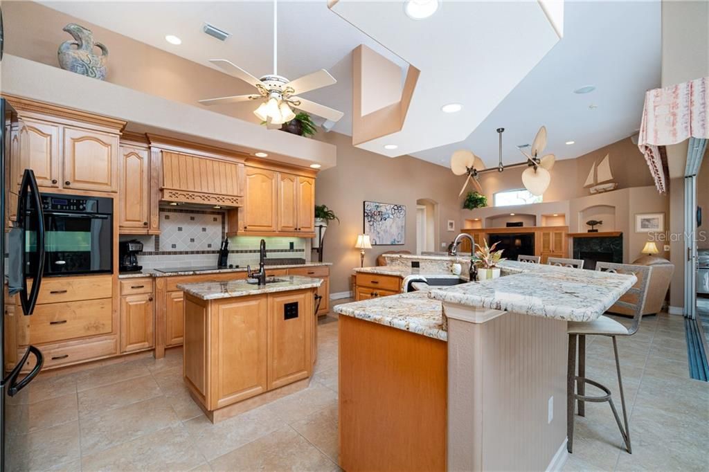 Open kitchen enjoys granite tops and expansive breakfast bar.