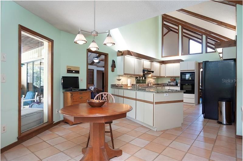 The kitchen dinette area is large and has a perfect view and access to the lanai and pool.