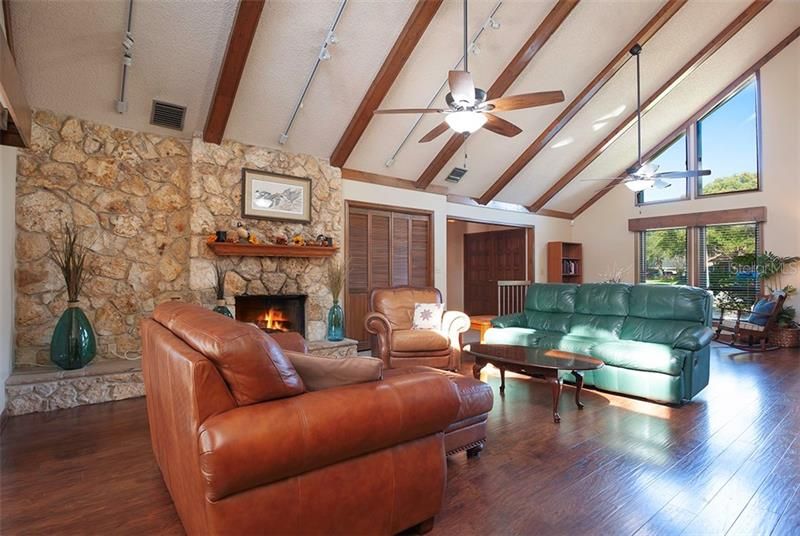 Huge living room with 22' ceilings and impressive wood burning fireplace!