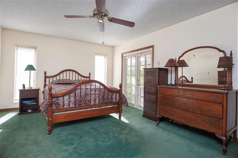 The spacious master bedroom has pool access.