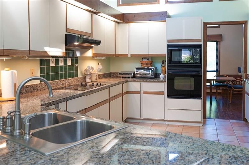 Granite countertops compliment the modern looking kitchen.