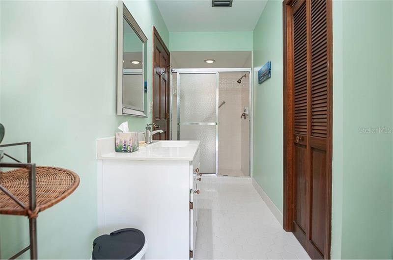 The guest bath has a walk-in shower, newer cabinet and quartz counter top.