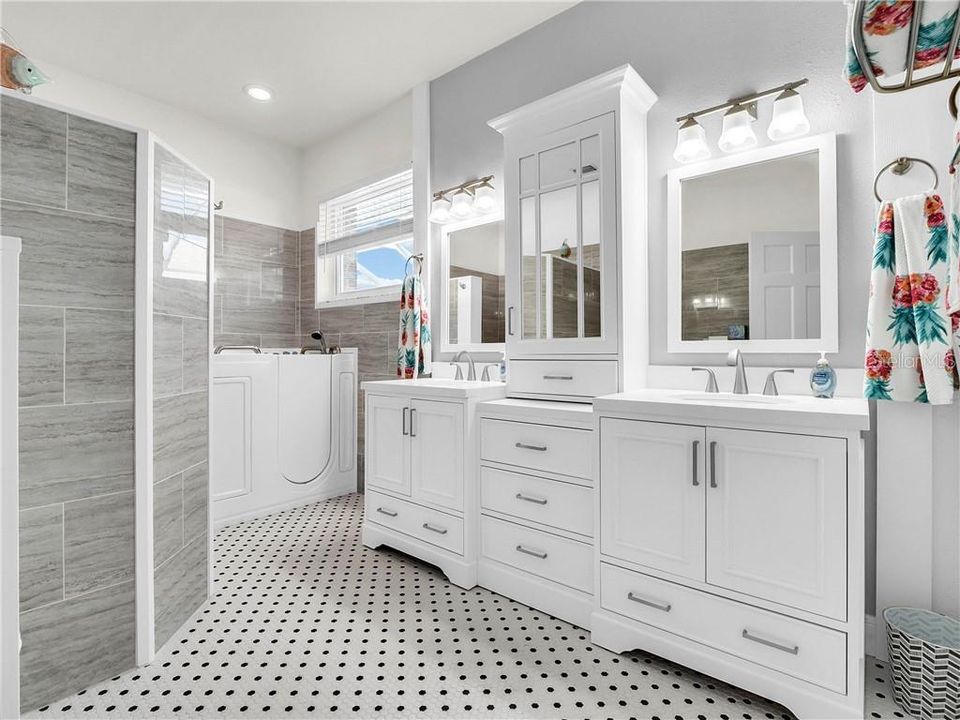 Master bathroom with dual sinks & a walk in Jacuzzi tub.