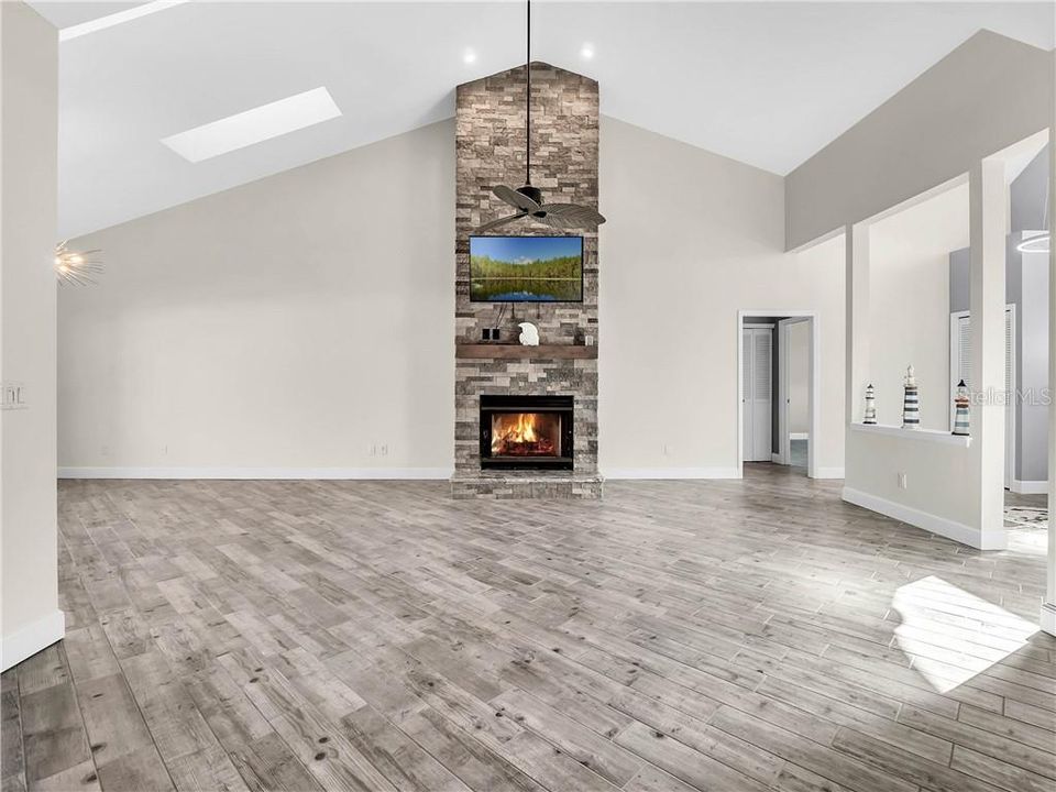 Living room with beautifully redone stone fireplace.