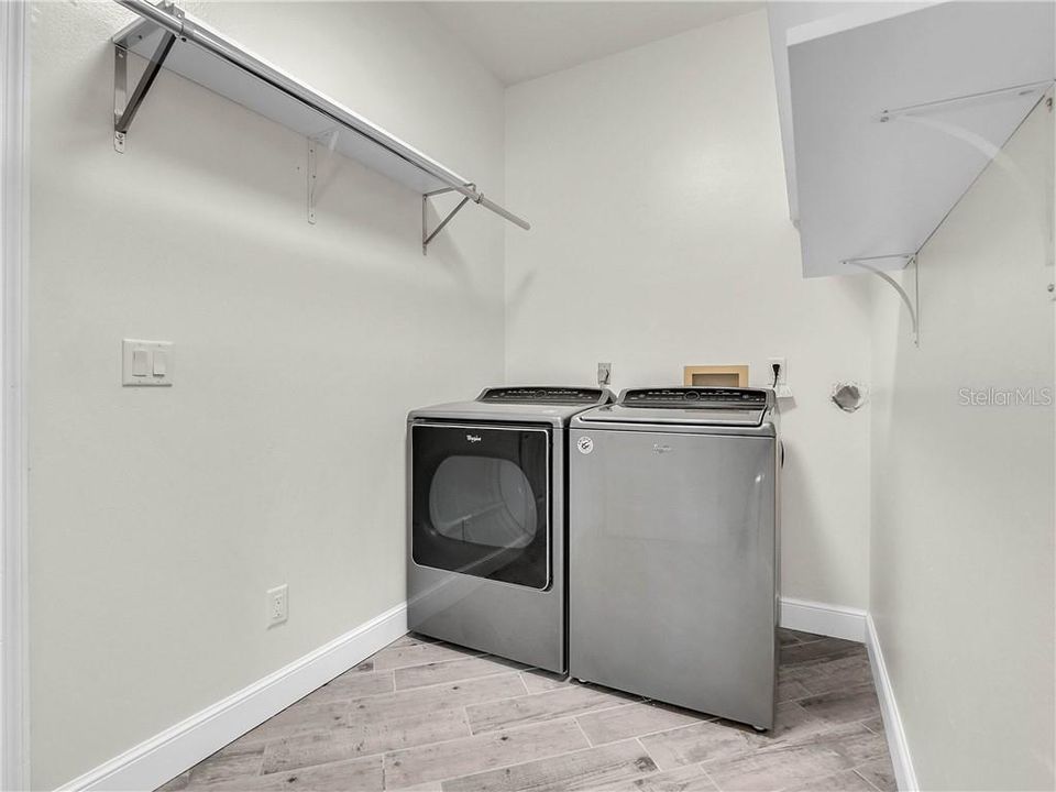 Inside laundry room with a washer & dryer that stay with the home.