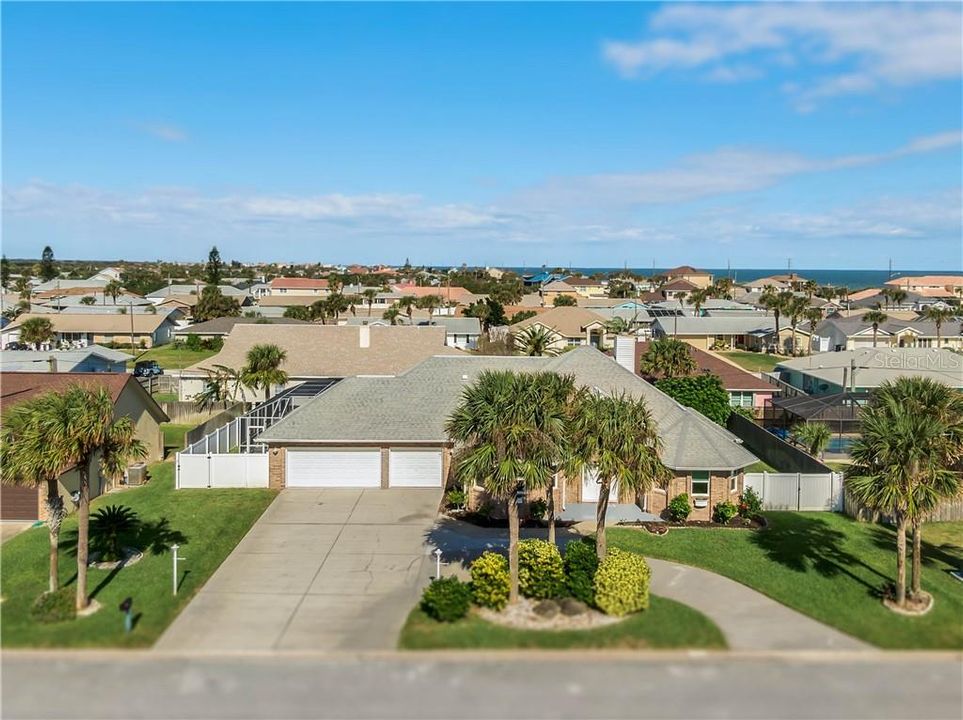 You can see the ocean in the background. Lots of parking with a circular driveway.  Small boat parking on the right side of the home behind the double gate.