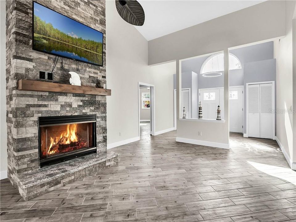 Lovely fireplace in the living room, foyer area with closets on both sides. The 2nd & 3rd bedroom & a bath are off to the left. Great split plan for privacy.