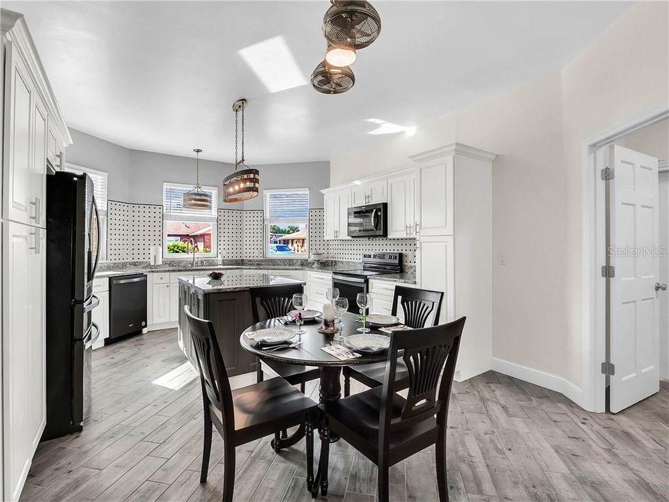 Awesome fan/light fixture above the kitchen table. The inside laundry room is off to the right.