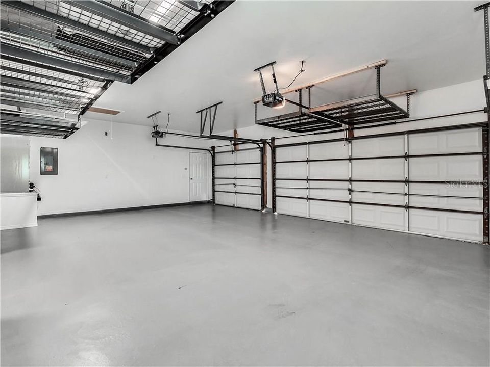 3 car garage with automatic door openers & storage racks installed in the ceiling. Pull down stairs to the attic.