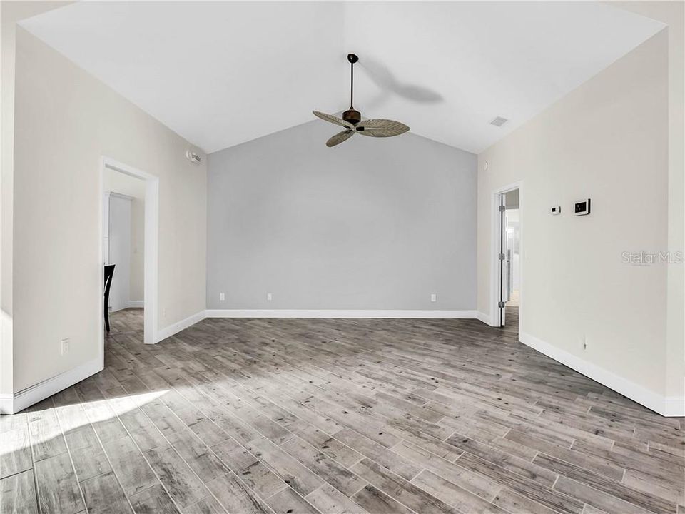 Living room with kitchen off to the left & master bedroom off to the right.