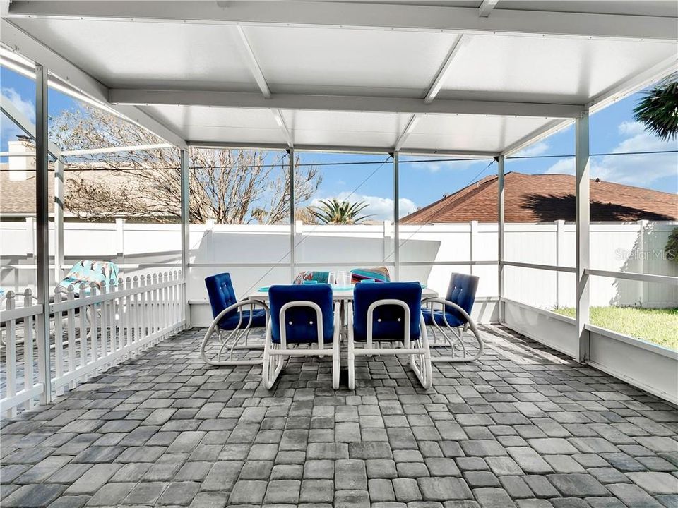 Covered lanai with new pavers & new roof over the covered area. All new screen.