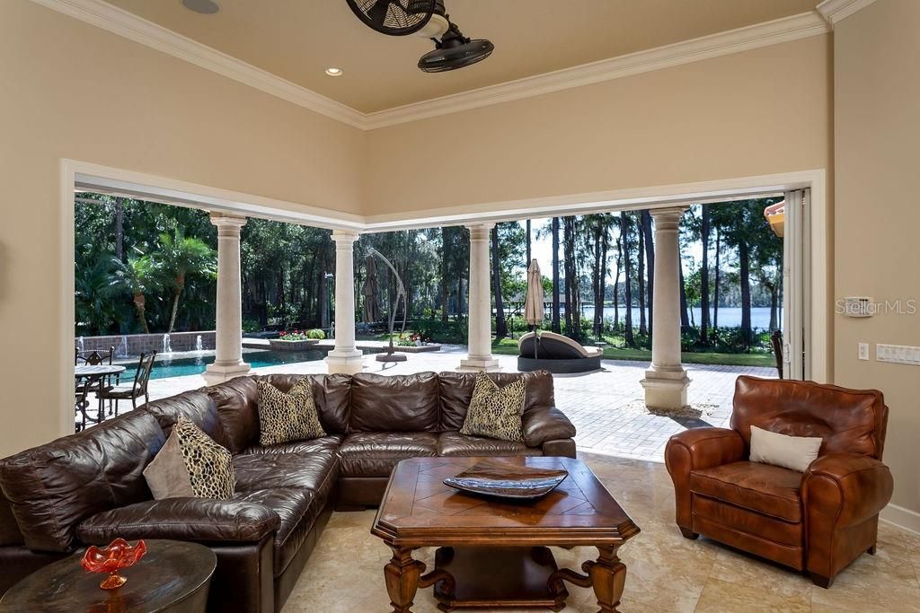 Family room with sliding doors that recess into the walls for the ultimate indoor/outdoor living and entertaining.