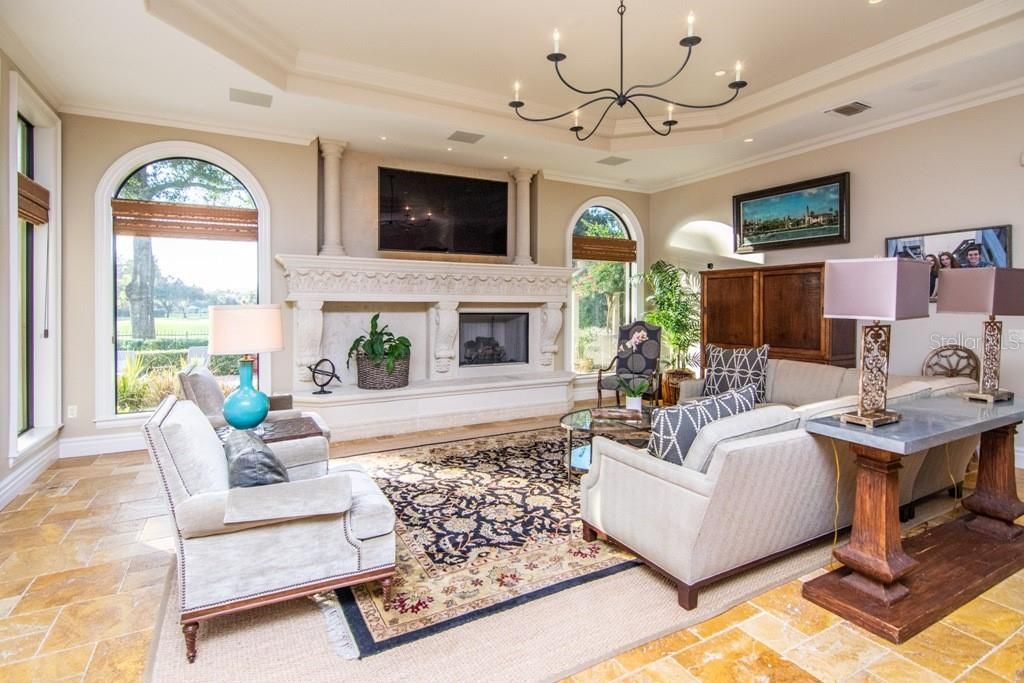 Family Room with Beautiful Stone Fireplace and Great Views of Golf Course