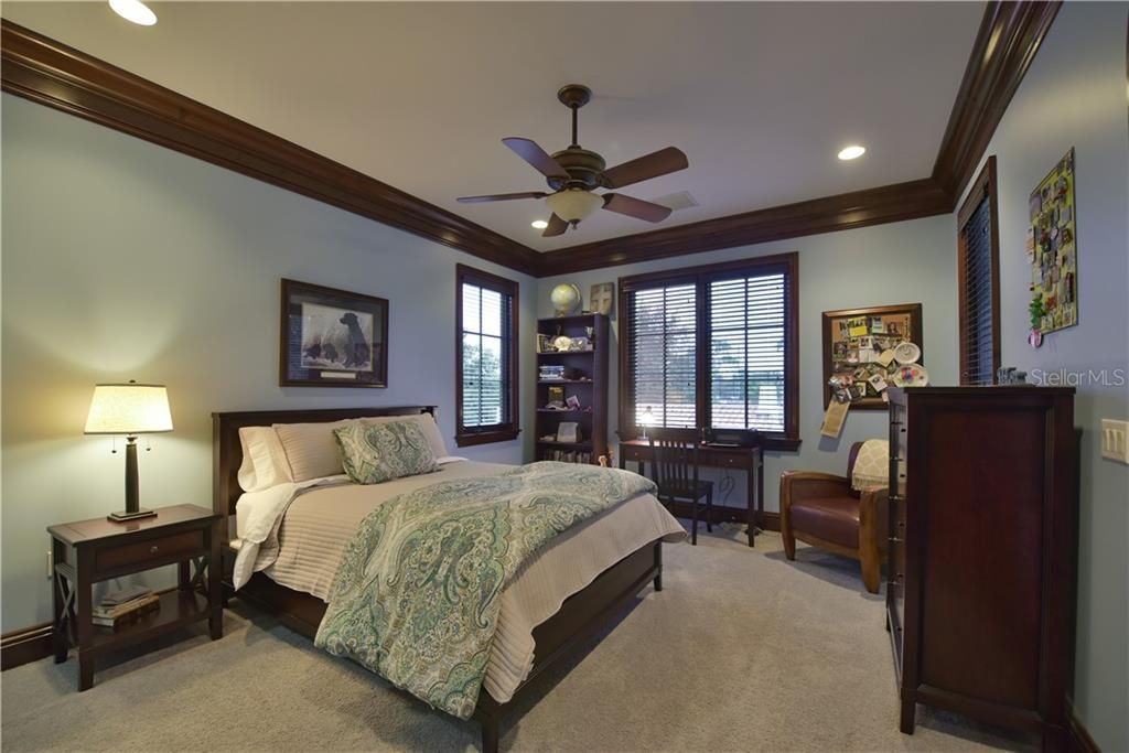 Spacious secondary bedroom with multiple windows and access to private balcony.