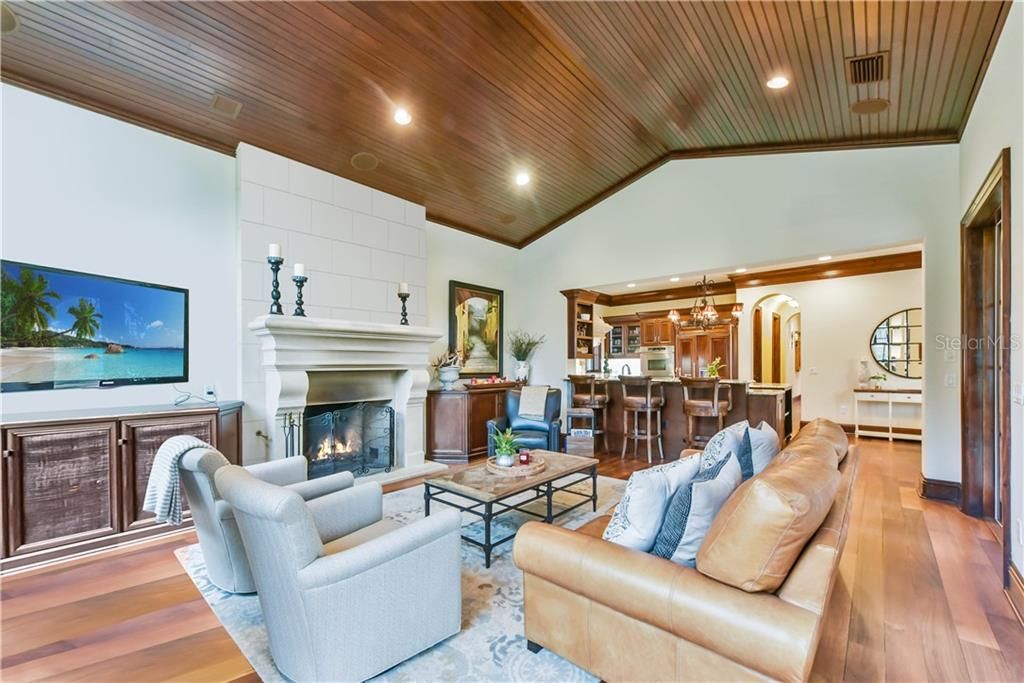 Spacious gathering space with wood burning fireplace, tongue and groove ceiling, and a great entertaining flow.