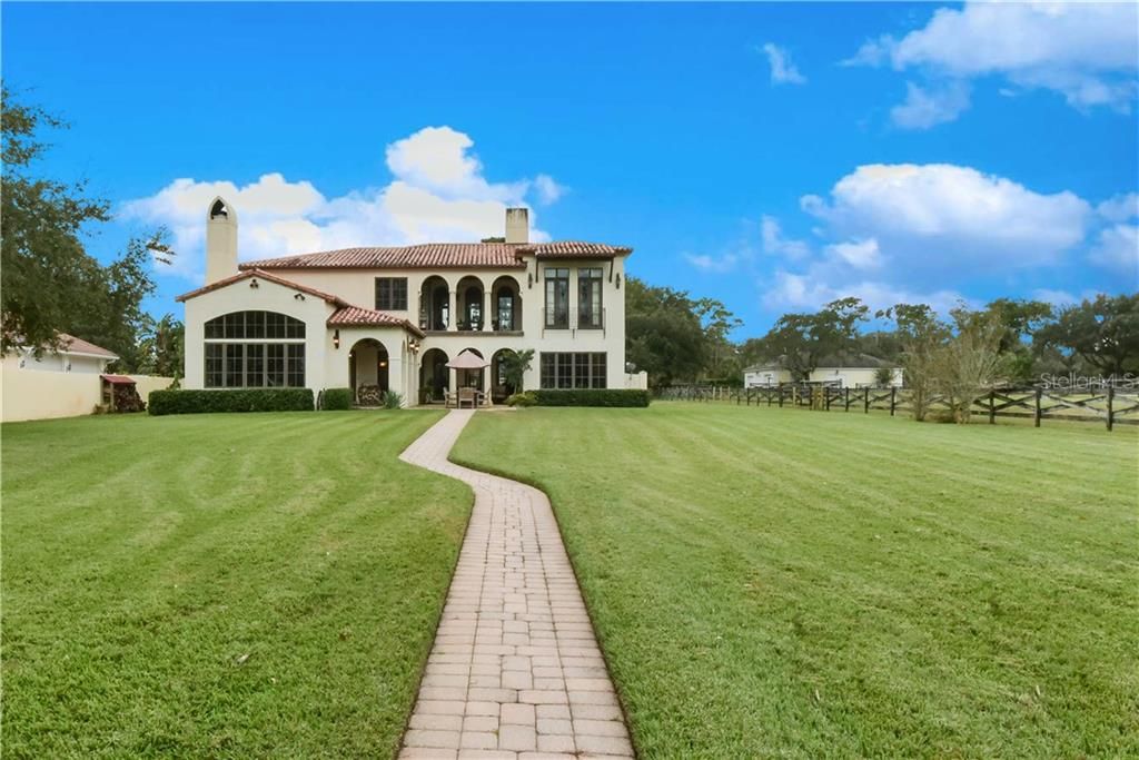 Rear elevation and TWO ACRES OF PRISTINELY MANICURED GROUNDS.