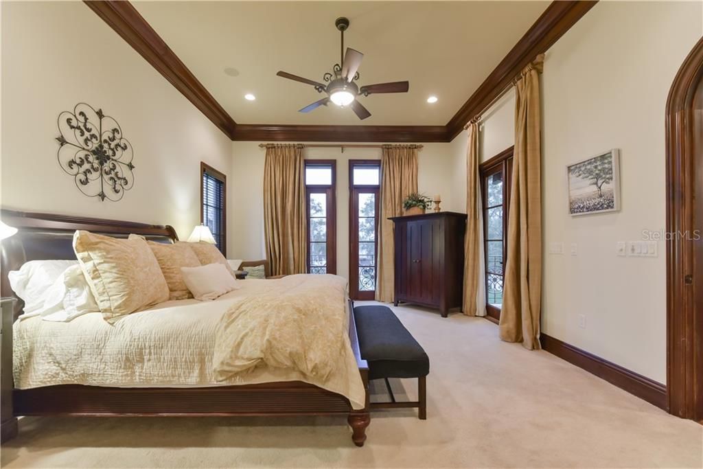 Owner's retreat. Tall ceilings, crown molding, and French doors to balcony overlooking the lake.