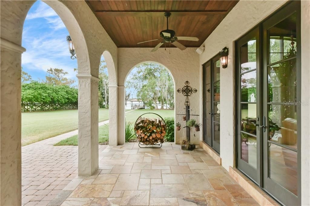 Beautiful archways frame the views and invite you into the large and spacious backyard.