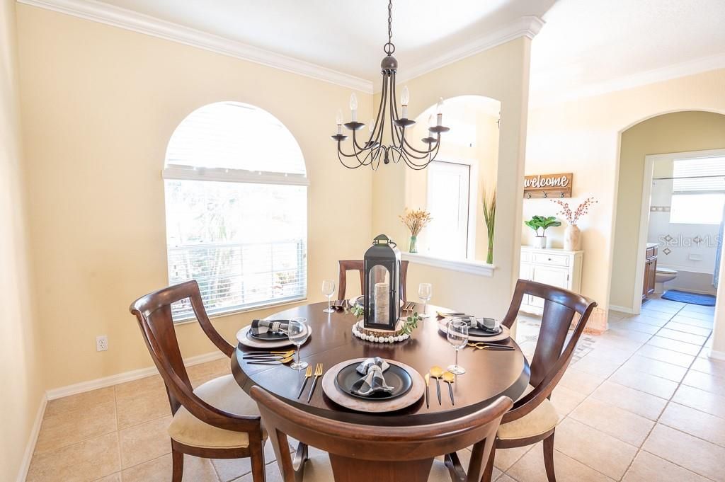 Formal Dining Room with Chandelier and Arched Windows.
