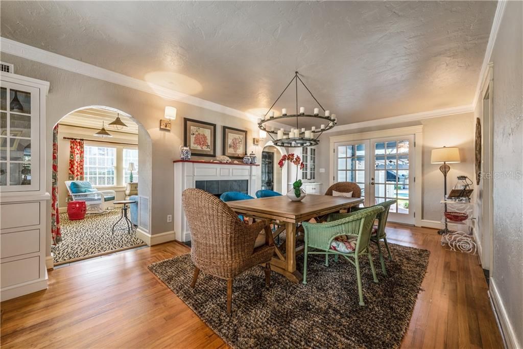DINING ROOM offers a beautiful WOOD BURNING FIREPLACE, FRENCH DOORS, CROWN MOLDING and an awesome CHANDELIER that centers the room!