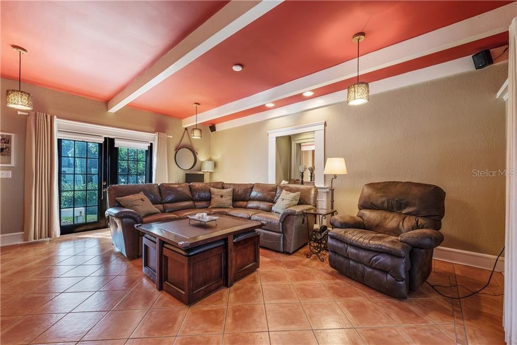 Spacious FAMILY ROOM featuring HIGH CEILINGS with BEAMS, MULITPLE FRENCH DOORS, a convenient WETBAR with RECESSED LIGHTS making it a wonderful space to hang out with friends and family!