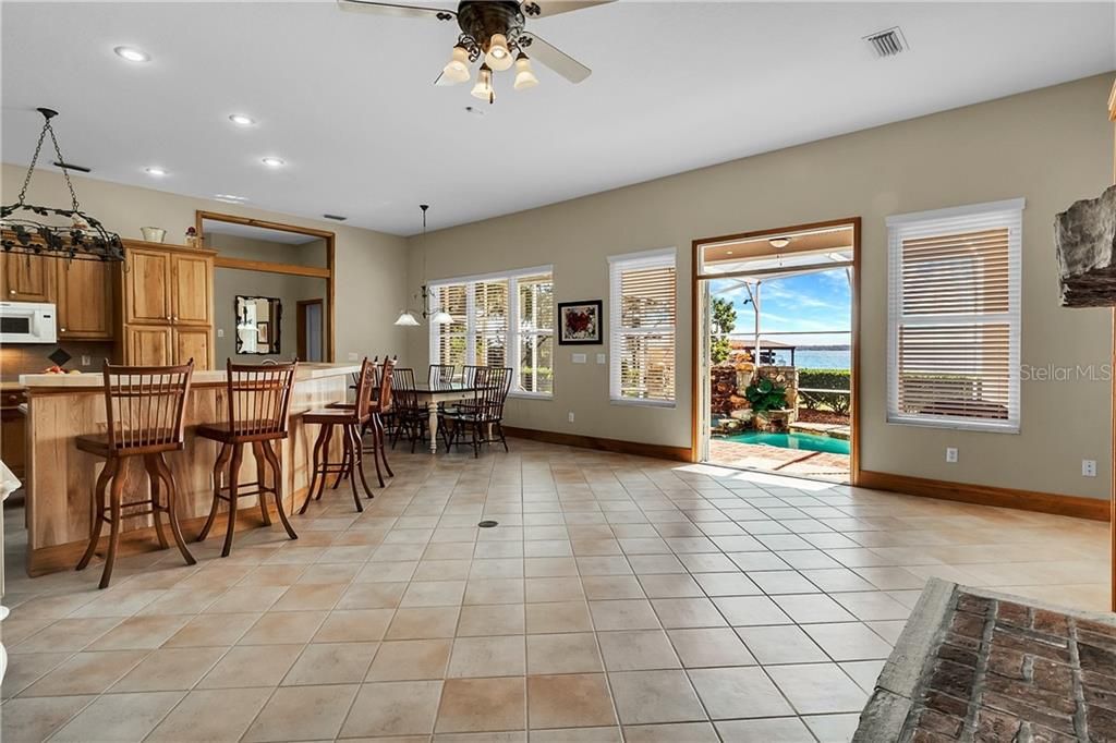 The ample dinette space and open kitchen overlooks the family room.