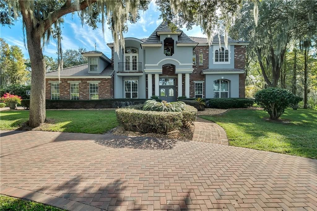 One of a kind majestic French Country Estate on the Clermont Chain of Lakes boasting over 600 feet of lake frontage on Lake Minneola.