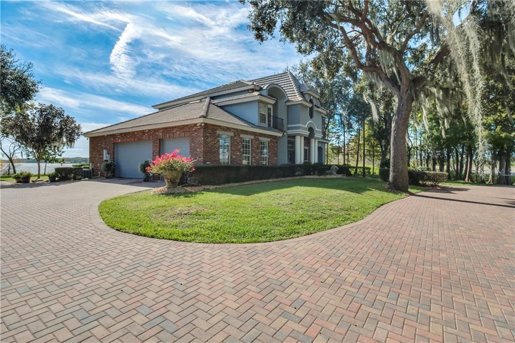 The home features an oversized 3 car garage and a paver driveway.