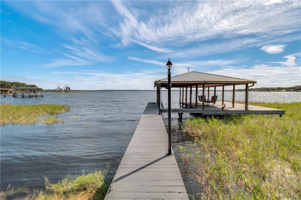 This amazing house boasts its own private boat ramp and an oversized dock with a boat lift .
