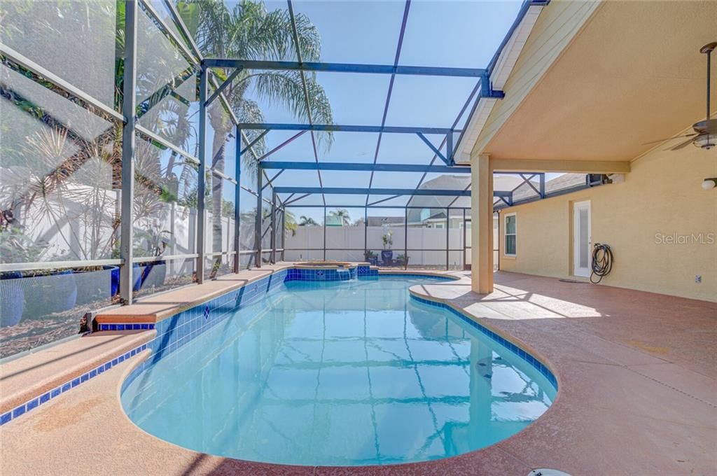 Crystal clear Pool and Spa with new tile details. This Lanai has plenty of room for entertaining.