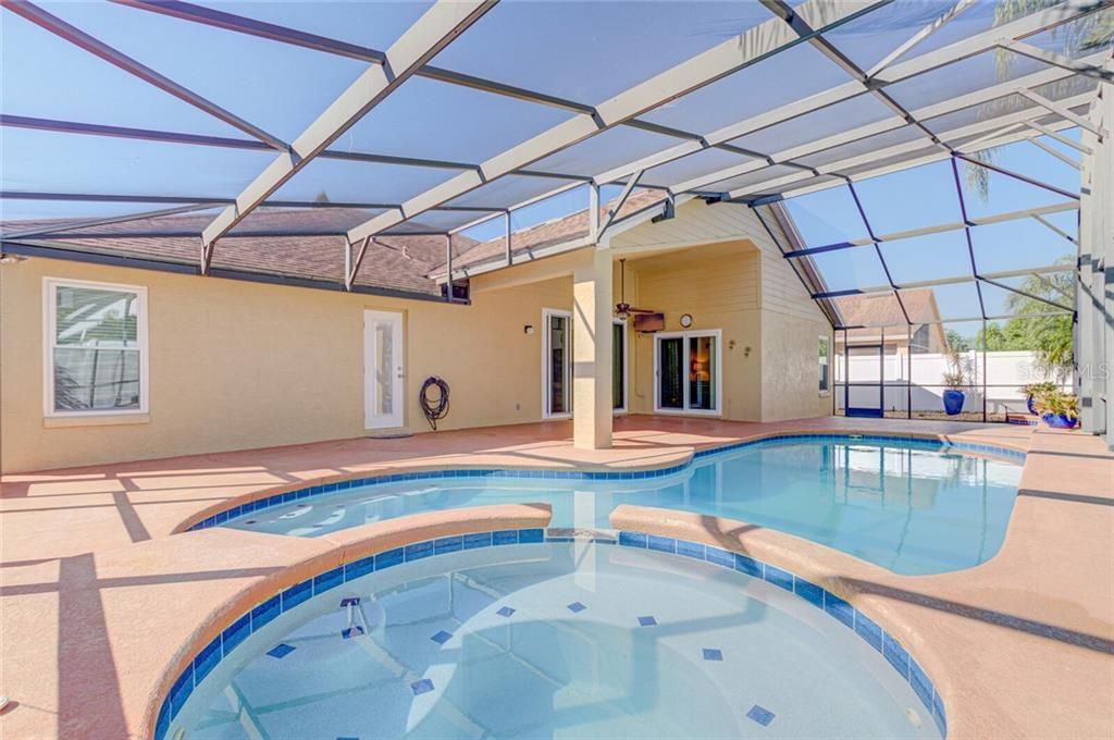 Crystal clear Pool and Spa with new tile details. This Lanai has plenty of room for entertaining.