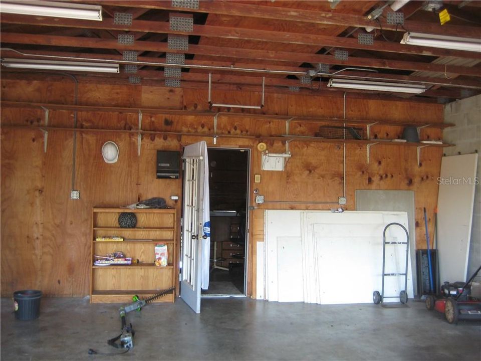 Shows the door that enters from the interior of the garage to the workshop.