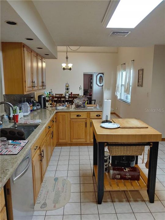Kitchen showing tiled flooring.   Solid wood cabinets and granite countertops.