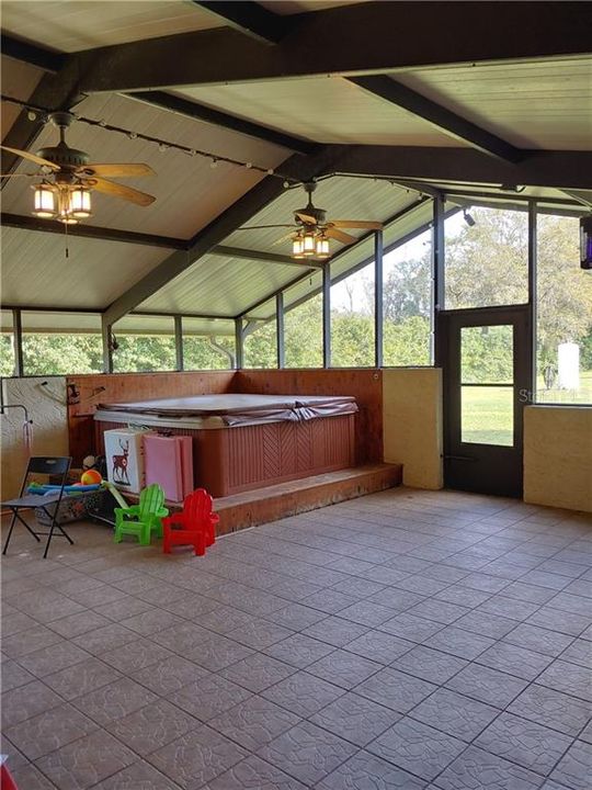 Door enters from walk way from garage.  Screened open air lanai with pool table, hot tub, darts and sound system.  This room is a great size at an approximate measurement of 26x29!!